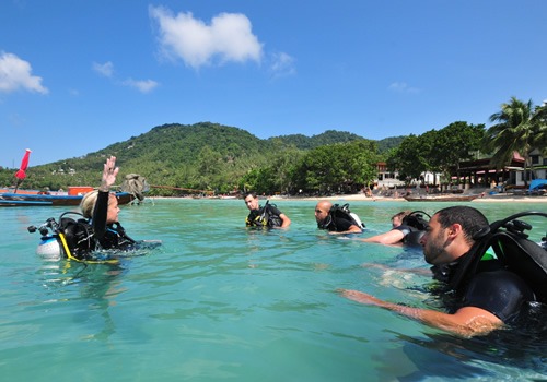 Experienced instructor with students in confined water