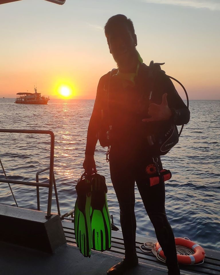 Night diver at sunset